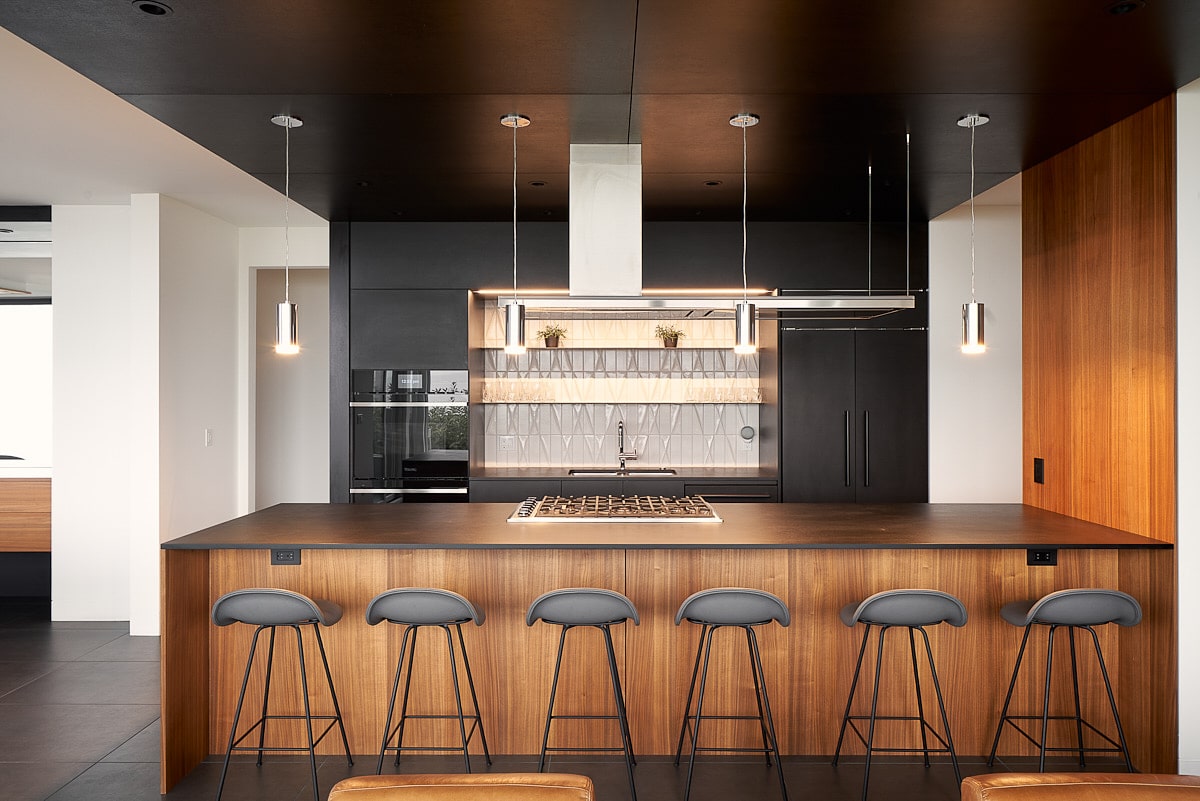 kitchen view in wood and dark metal ceiling with stools